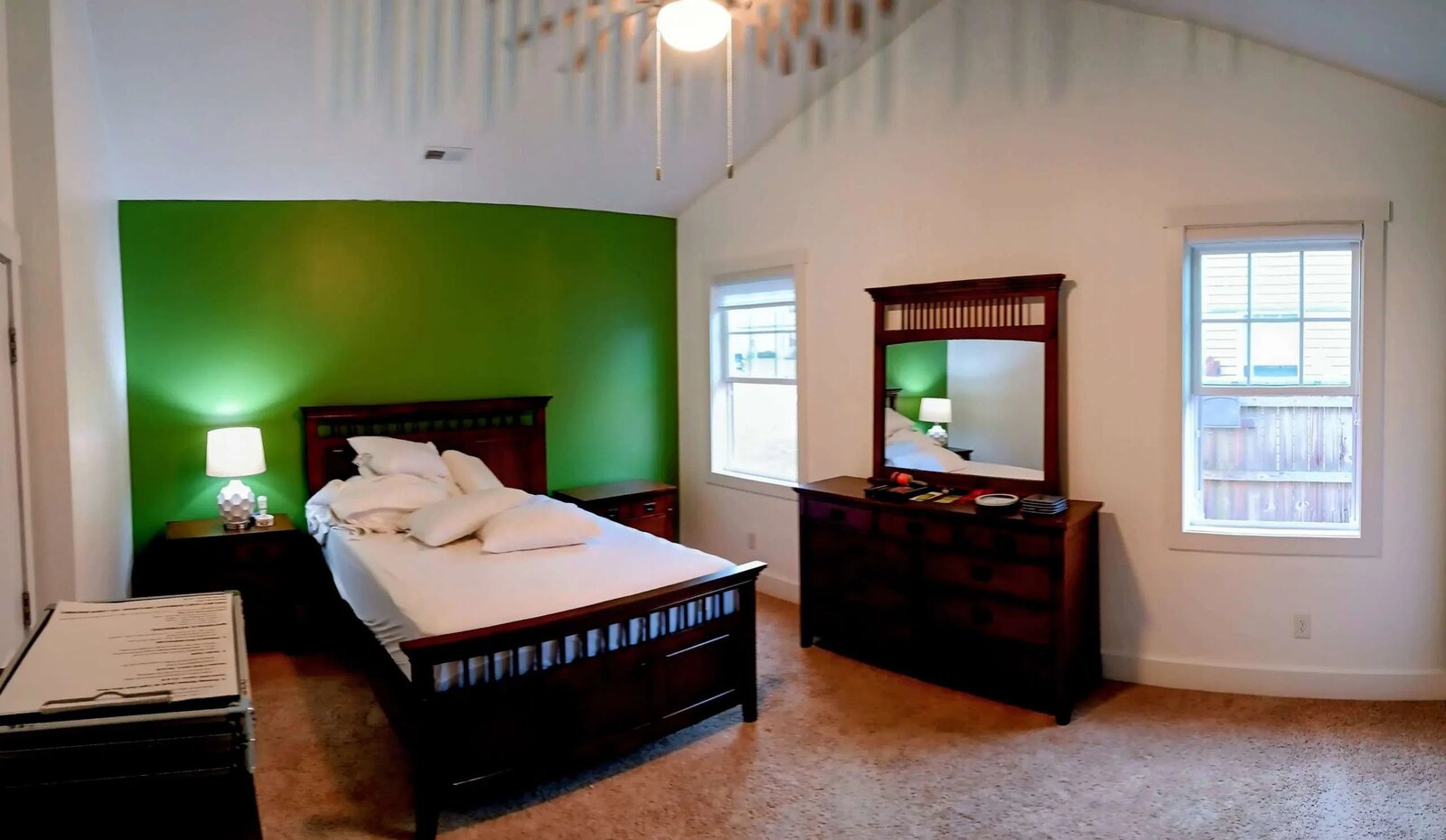 Master bedroom with vaulted ceiling and hunter-green accent wall — Johnson City