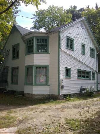 Restored Victorian-era home with white siding and heritage green trim — Jonesborough