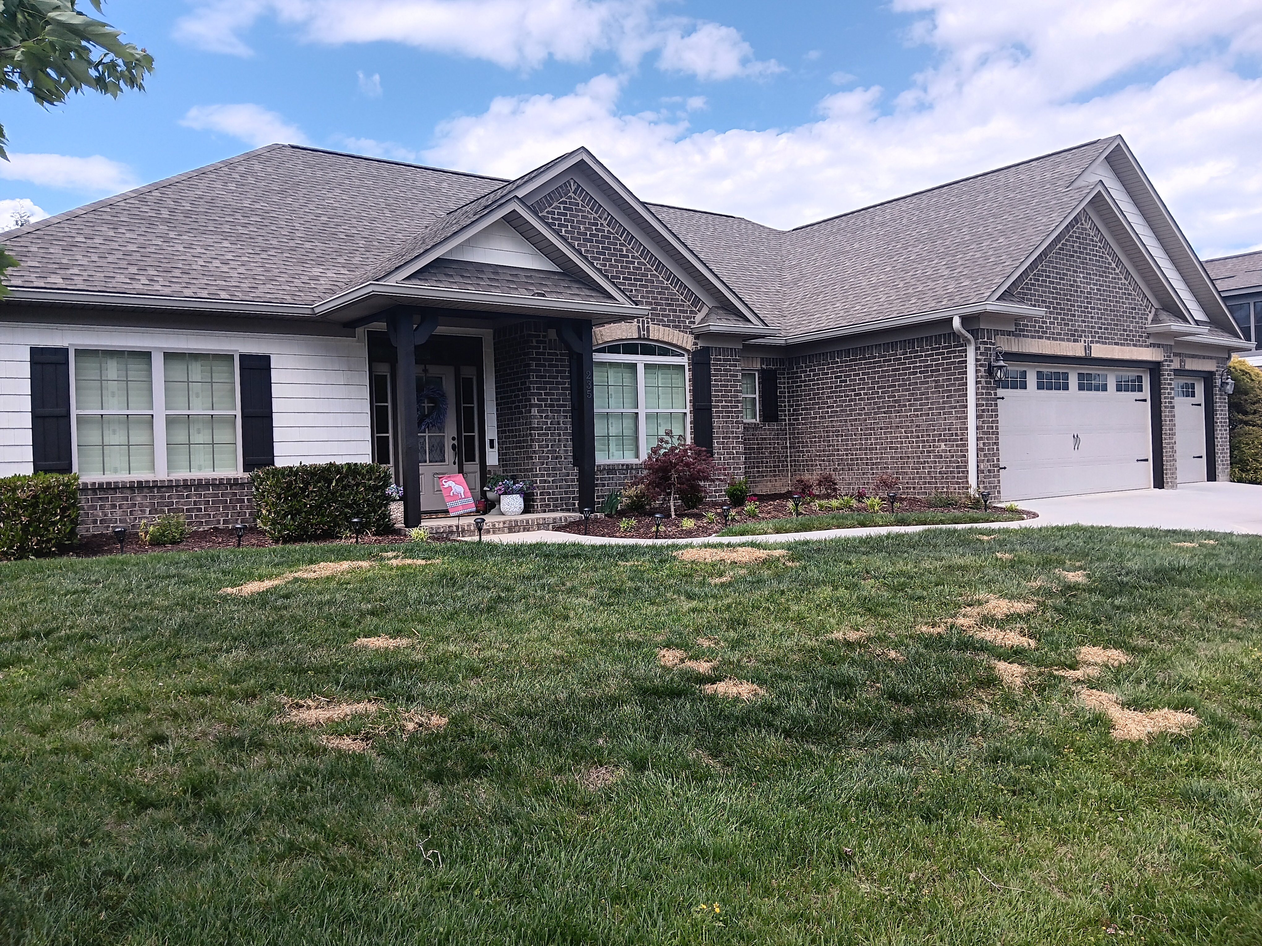 Front porch pillars, shutters, and garage trim stained in Sherwin-Williams Woodscapes Dark Walnut in Jonesborough TN